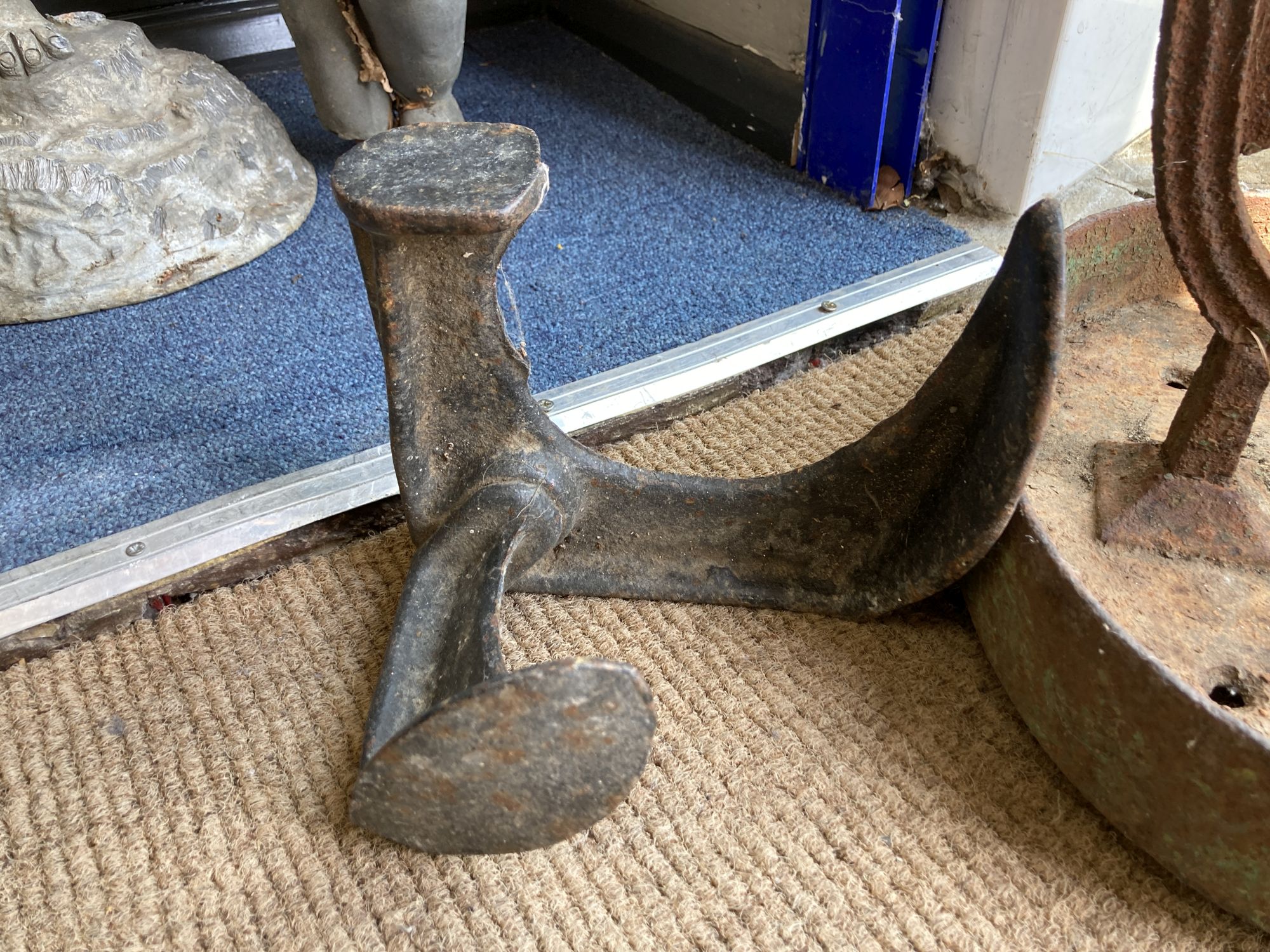 A Victorian cast iron boot scraper, width 33cm, height 26cm together with a cast iron Cobbler's last